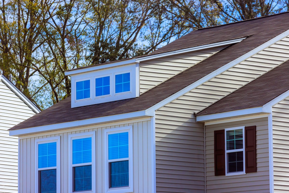 Well designed two story house displays multiple windows exterior features siding sloped roof, American town enhancing its residential area
