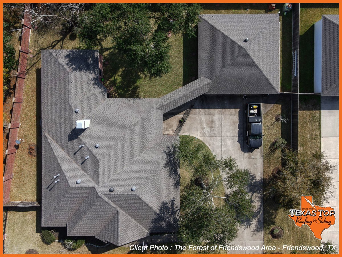 Aerial view of residential driveway with manicured lawn