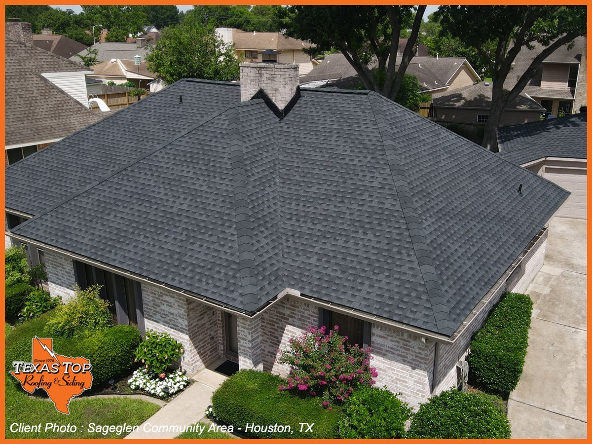 Aerial view of modern single-story home with dark gray shingle roof